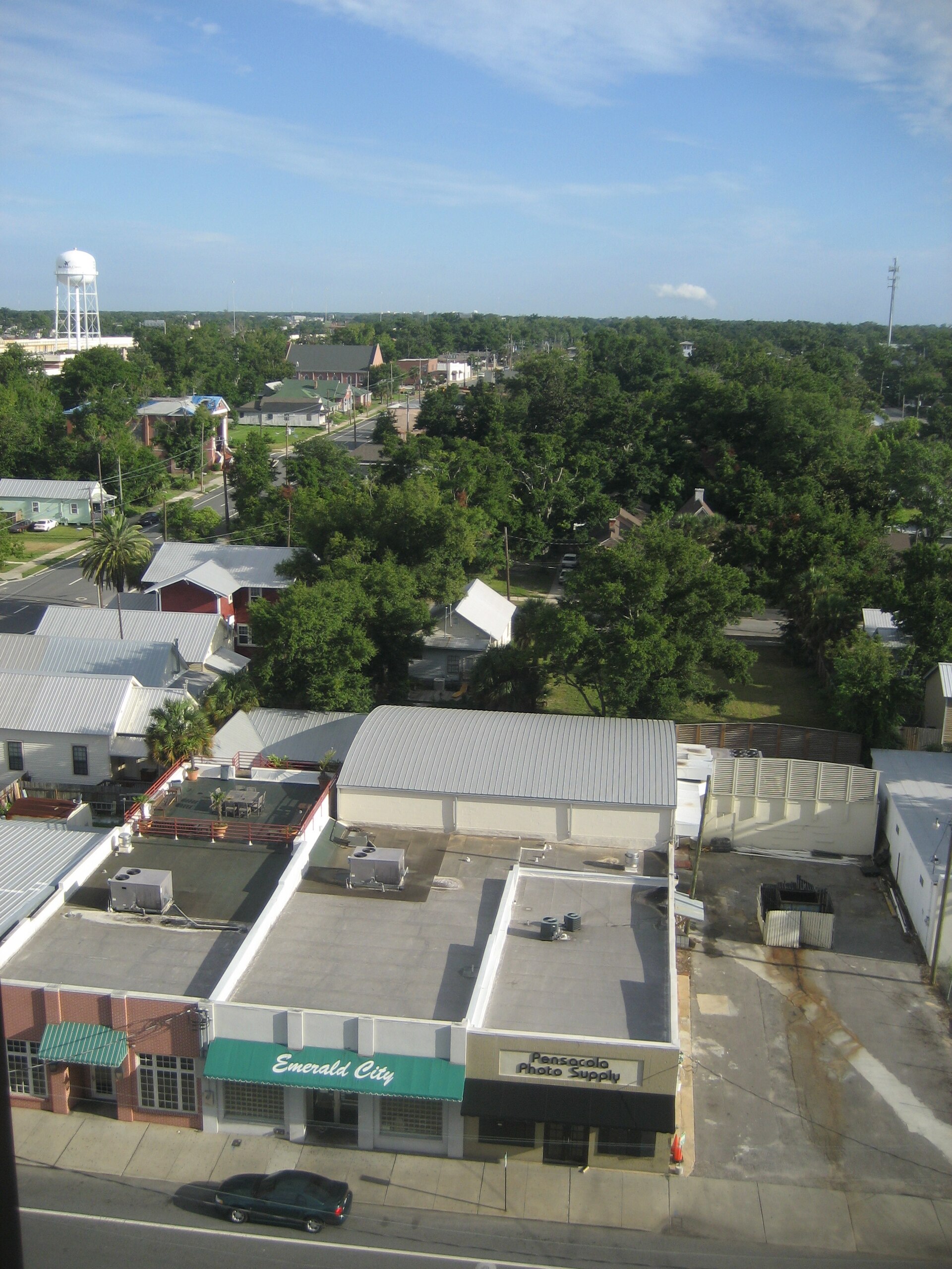 Rooftops, streets and tree-lined blocks of central Pensacola, Florida seen from above