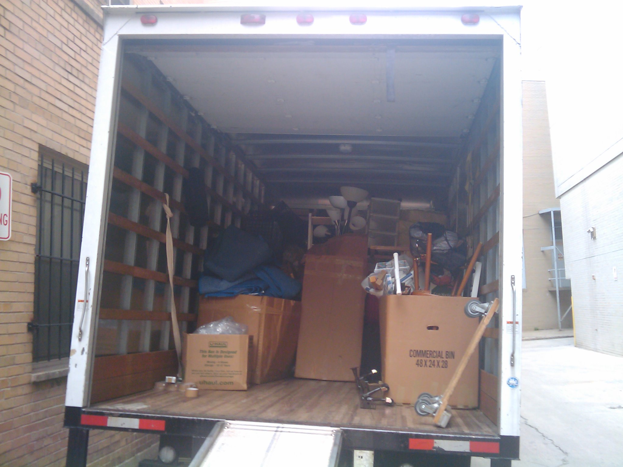 A loaded moving truck with household boxes and furniture ready for a household goods move