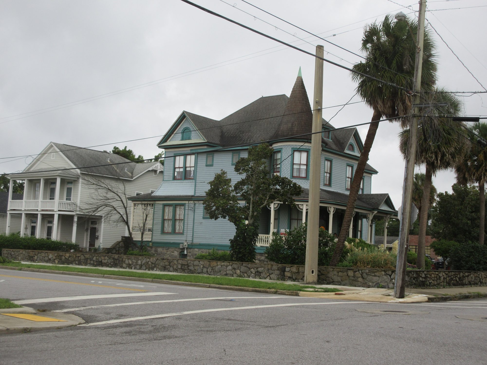 A residential street of single-family homes with mature trees in Pensacola, Florida